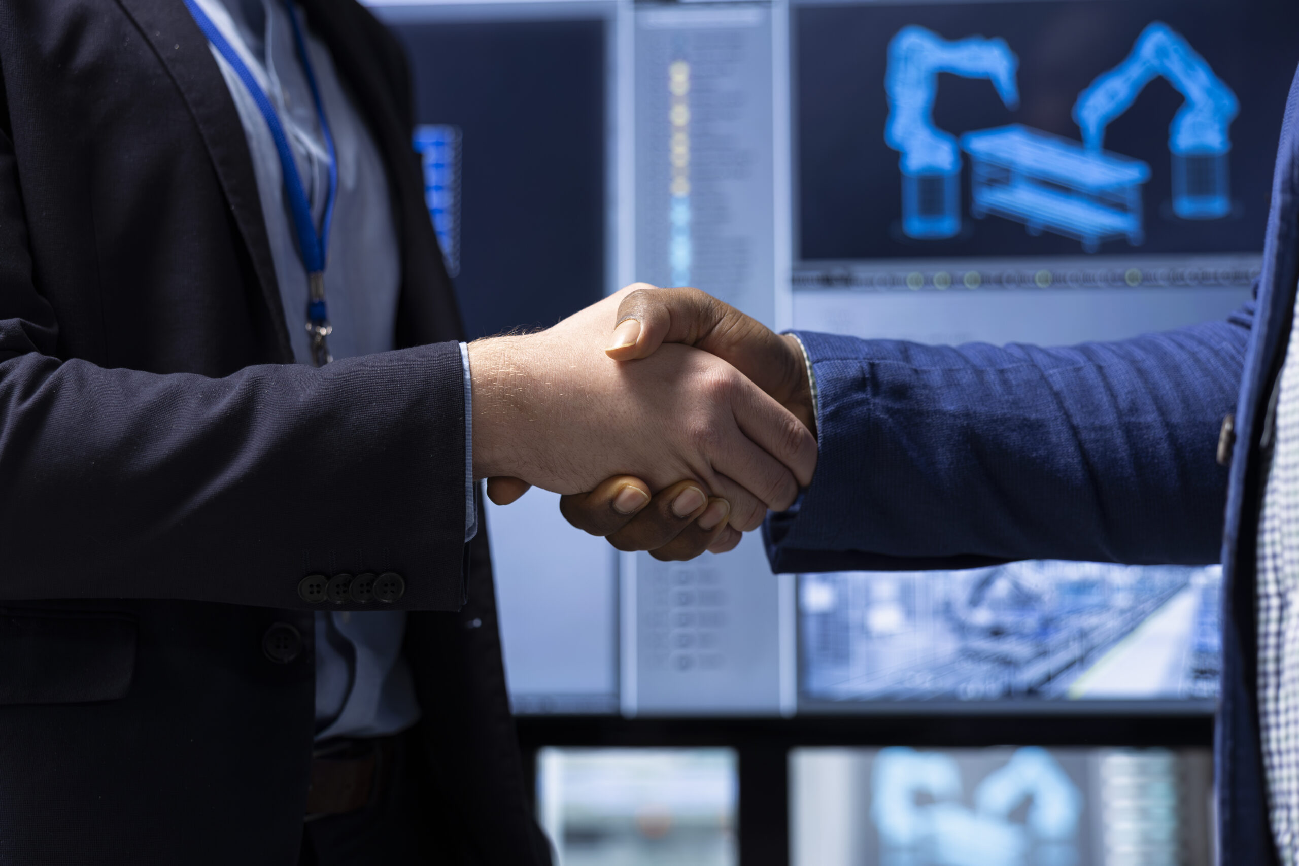 Investor shaking hands with factory manager after finding no issues, closeup